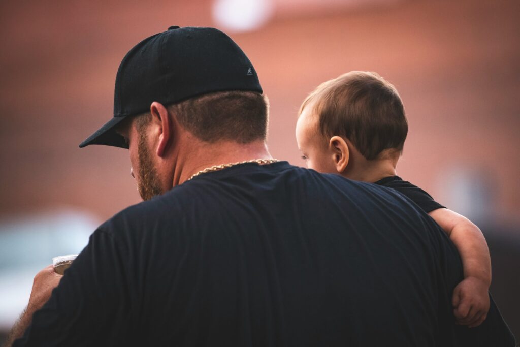 New dad holding his child outdoors